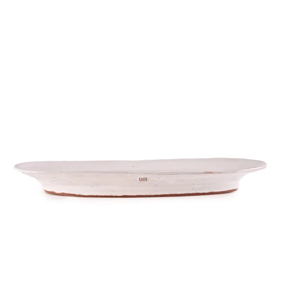 Perfect Hideaways: Side profile of a ceramic fish platter with a natural white glaze and rustic terracotta base. Perfect Hideaways shop