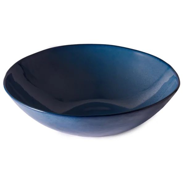 Perfect Hideaways: A large deep blue ceramic serving bowl with smooth curves and a glossy surface that reflects light. Perfect Hideaways shop