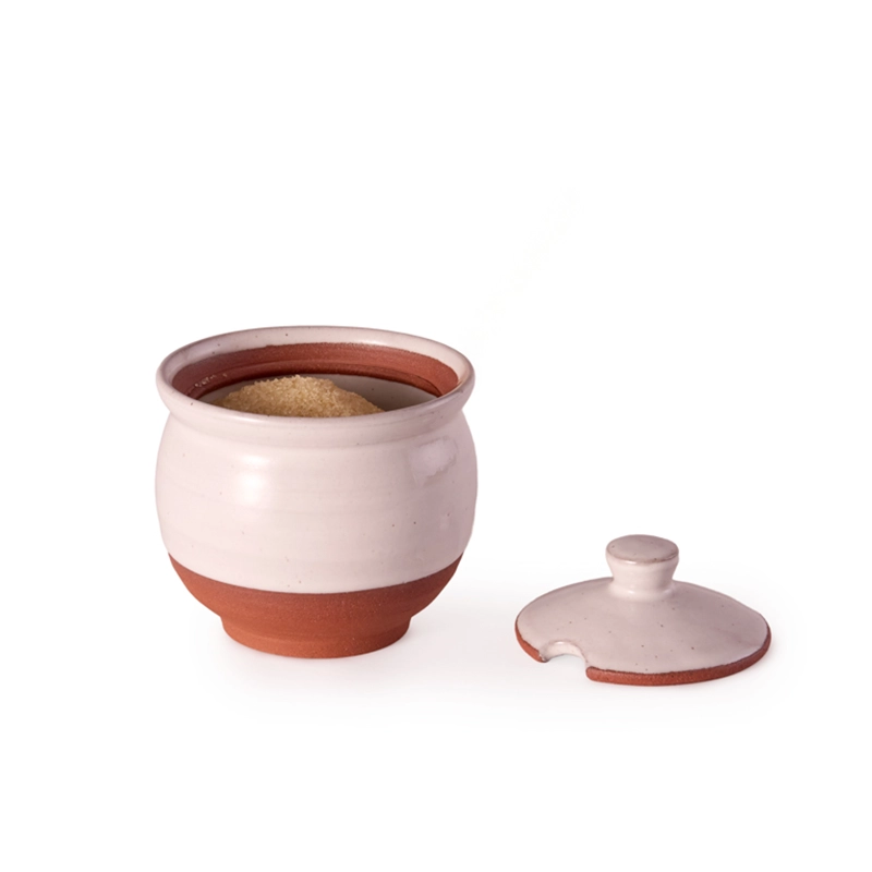 Perfect Hideaways: A Country Sugar Bowl with a terracotta base and soft white glaze, filled with brown sugar and displayed with its matching lid set aside. Perfect Hideaways shop.