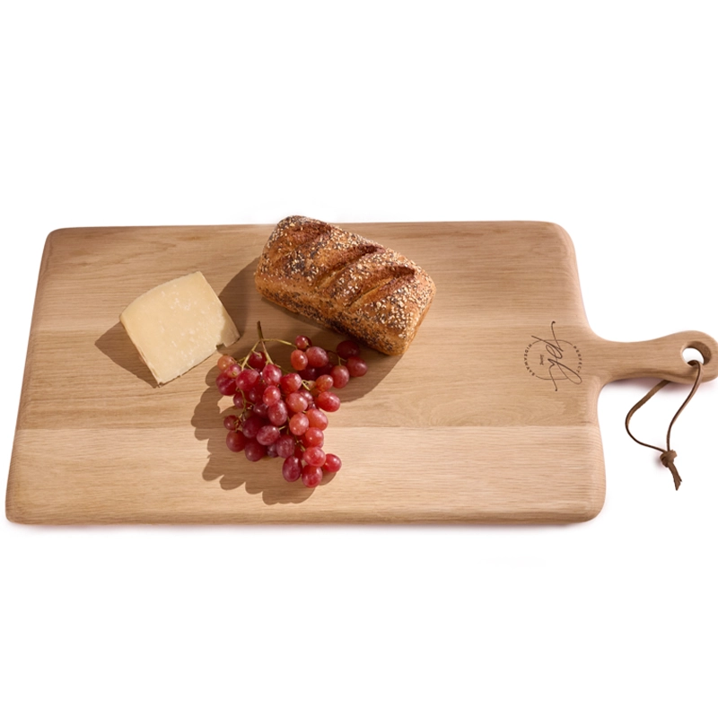 Perfect Hideaways: A beautifully crafted Oak Rectangular Paddle serving board topped with seeded bread, red grapes, and a wedge of cheese, perfect for stylish entertaining or rustic kitchen display. Perfect Hideaways shop