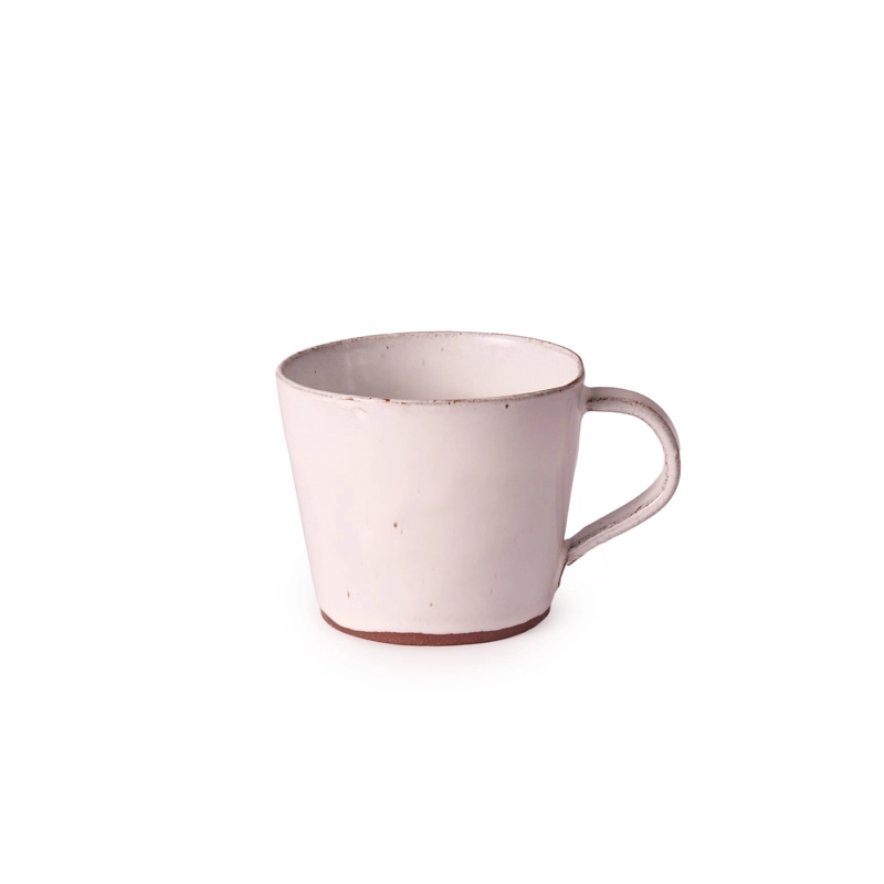 Perfect Hideaways: A handcrafted Classic Conical Mug with a wide cylindrical form, soft blush-pink glaze, and rustic terracotta base, featuring a vertical handle and an impressed maker’s mark. The shop