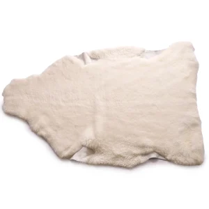 Perfect Hideaways: A full ivory sheepskin rug with a natural, irregular shape and soft, dense texture, displayed on a white background. Perfect Hideaways shop