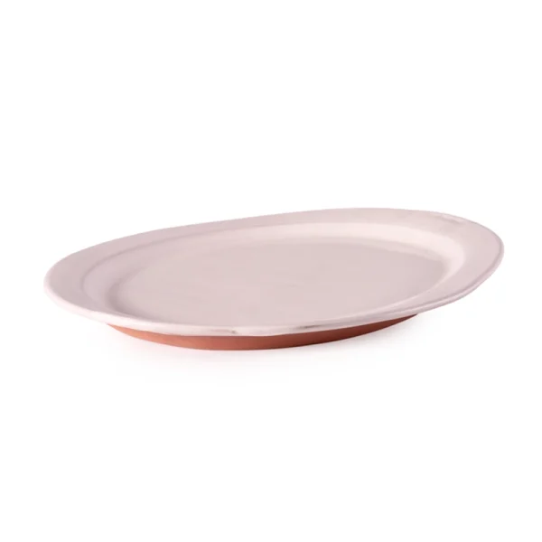 Perfect Hideaways: Side profile of an elegant handcrafted country oval platter featuring a white glazed top and exposed terracotta base. Perfect Hideaways shop