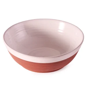 Perfect Hideaways: A handcrafted country serving bowl in a terracotta and cream glaze, shown empty to highlight its elegant shape and subtle texture. Perfect Hideaways shop