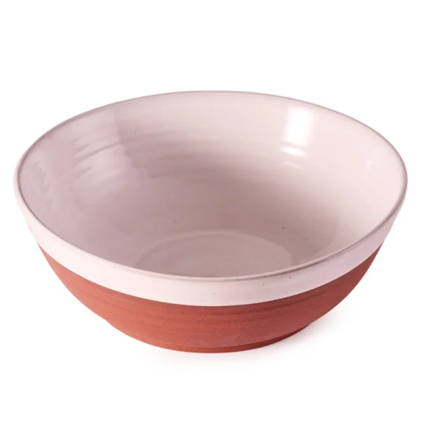 Perfect Hideaways: A handcrafted country serving bowl in a terracotta and cream glaze, shown empty to highlight its elegant shape and subtle texture. Perfect Hideaways shop