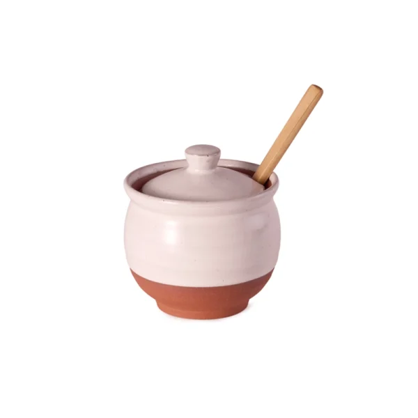 Perfect Hideaways: A handcrafted Country Sugar Bowl with a wooden spoon resting through a notch in the matching lid, blending terracotta and white-glazed tones. Perfect Hideaways shop.