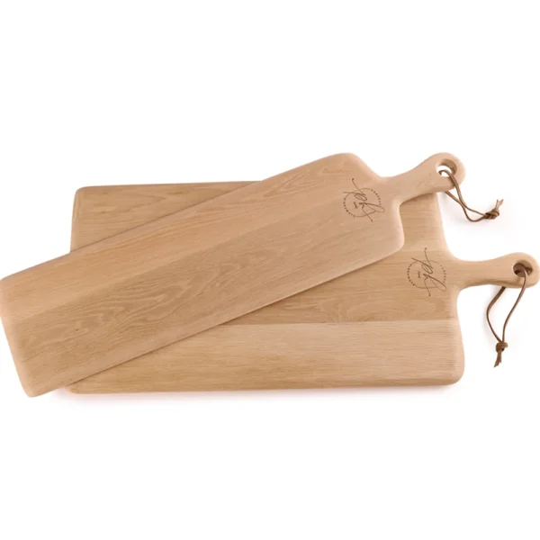 Perfect Hideaways: A pair of handcrafted oak narrow paddle boards with rounded edges and leather hanging loops, beautifully engraved with a signature mark. Perfect Hideaways shop