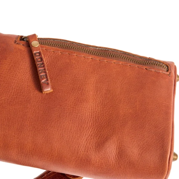 Perfect Hideaways: The Jack Sack. Close-up of the leather zip pocket on the yoga mat bag, featuring a sturdy zip pull embossed with the word “DONKEY.” Perfect Hideaways shop