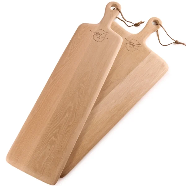Perfect Hideaways: A pair of long, Oak Rectangular Paddle serving boards with smooth finishes and leather ties, ideal for charcuterie, antipasti, or rustic table settings. Perfect Hideaways shop