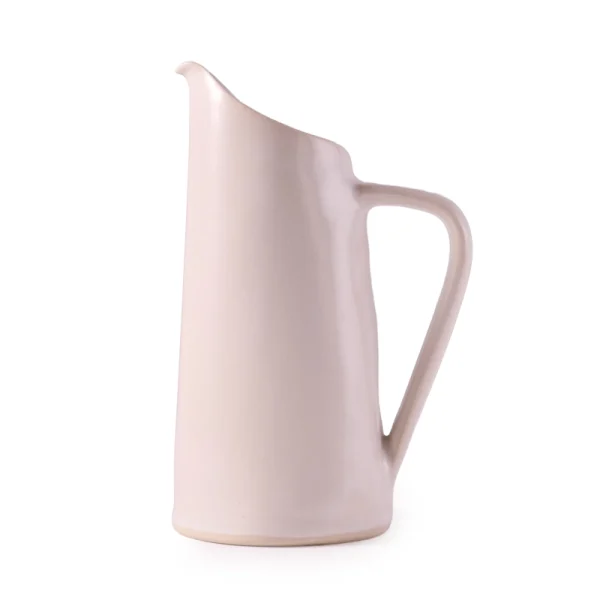 Perfect Hideaways: A side angle of the white ceramic water jug by Mervyn Gers, revealing the softly sculpted contours and matte finish. The shop