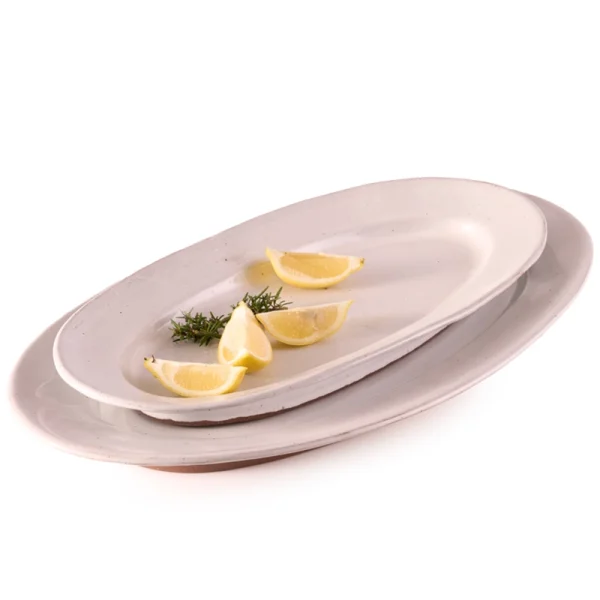 Perfect Hideaways: A set of handcrafted Classic Fish Platters in varying sizes, styled with lemon wedges and herbs for an elegant serving display. Perfect Hideaways shop