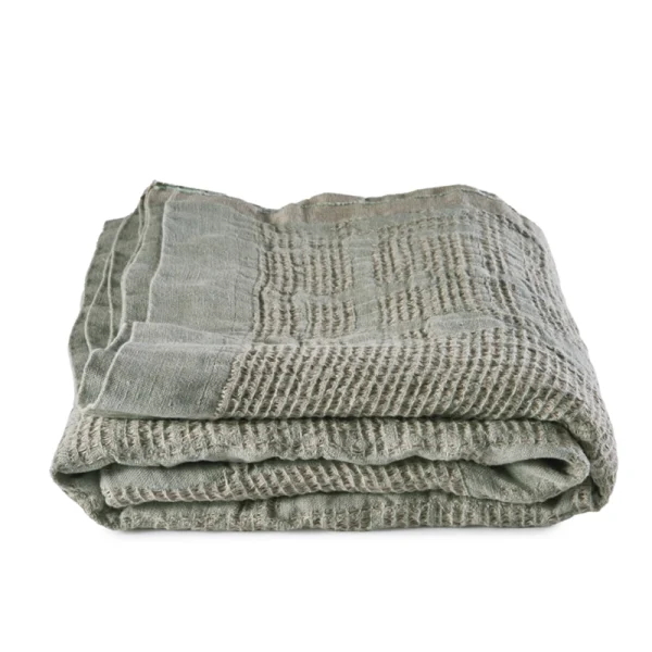 Perfect Hideaways: A neatly folded Celadon Bogolan Bed Throw with a rich, grid-like texture and soft, natural fabric perfect for layering. Perfect Hideaways shop
