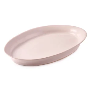 Perfect Hideaways: A soft white oval ceramic platter styled with a fresh green lime branch, blending natural beauty with handcrafted charm. The shop