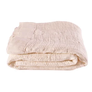 Perfect Hideaways: A neatly folded, Pearl Bogolan Bed Throw with a subtly textured surface and stitched edging, ideal for layering in a serene bedroom setting. Perfect Hideaways shop