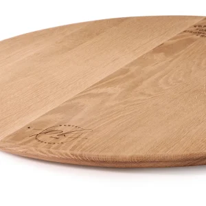 Perfect Hideaways: Close-up view of the oak cheese platter showcasing the fine grain detail, rounded edge, and engraved branding. Perfect Hideaways shop