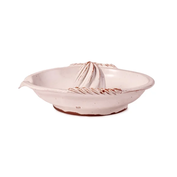 Perfect Hideaways: Side view of a white ceramic citrus juicer with textured rope-like handles and a terracotta base edge. Perfect Hideaways shop