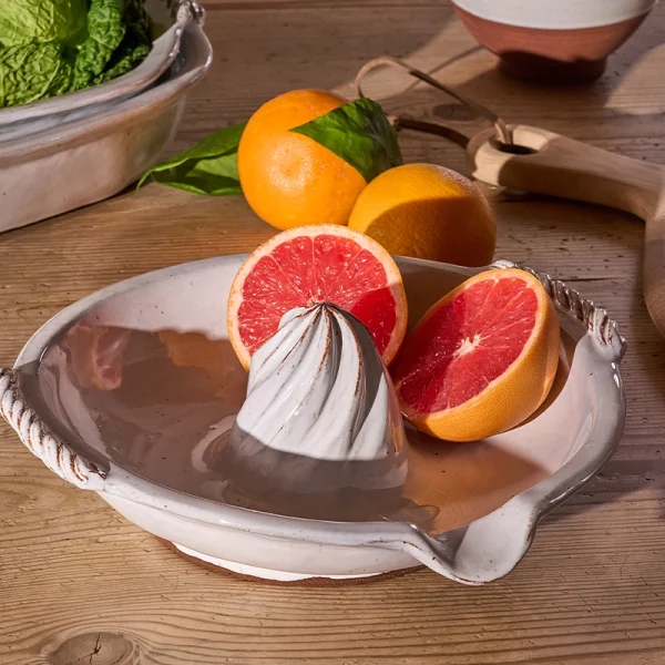 Perfect Hideaways: Citrus juicer styled on a wooden table with grapefruit and oranges, surrounded by fresh produce and kitchen tools. Perfect Hideaways shop