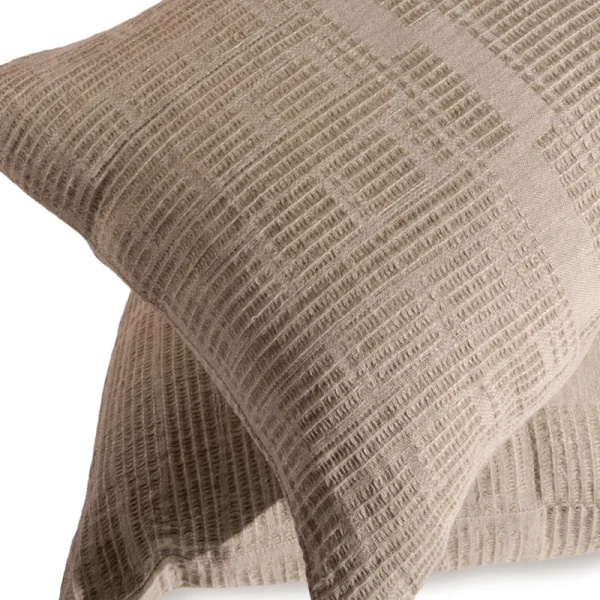 Perfect Hideaways: A close-up view of a Bogolan Classic Cushion Cover showing its intricate crosshatched weave in rich taupe tones, highlighting the craftsmanship and texture. Perfect Hideaways shop