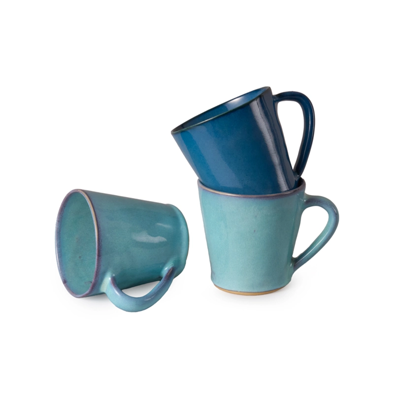 Perfect Hideaways handcrafted ceramic mugs in rich ocean-inspired tones of teal and deep blue, artfully stacked to showcase their smooth glaze and elegant shape, evoking coastal charm and artisan craftsmanship. Perfect hideaways shop.