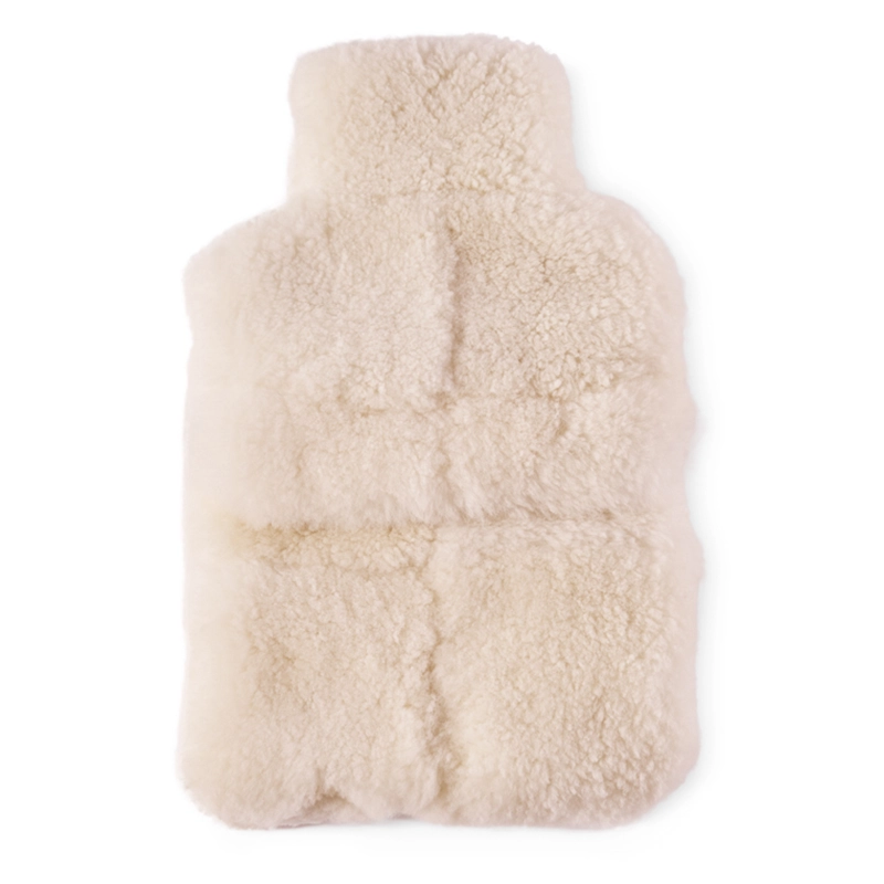 Perfect Hideaways: A plush ivory-coloured sheepskin hot water bottle cover with a soft, quilted texture designed for warmth and comfort. Perfect Hideaways shop