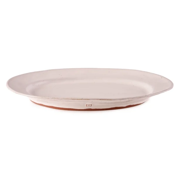 Perfect Hideaways: A single classic oval ceramic platter in a soft off-white glaze with a slightly irregular hand-shaped rim and terracotta base, photographed against a white background. Perfect Hideaways shop.