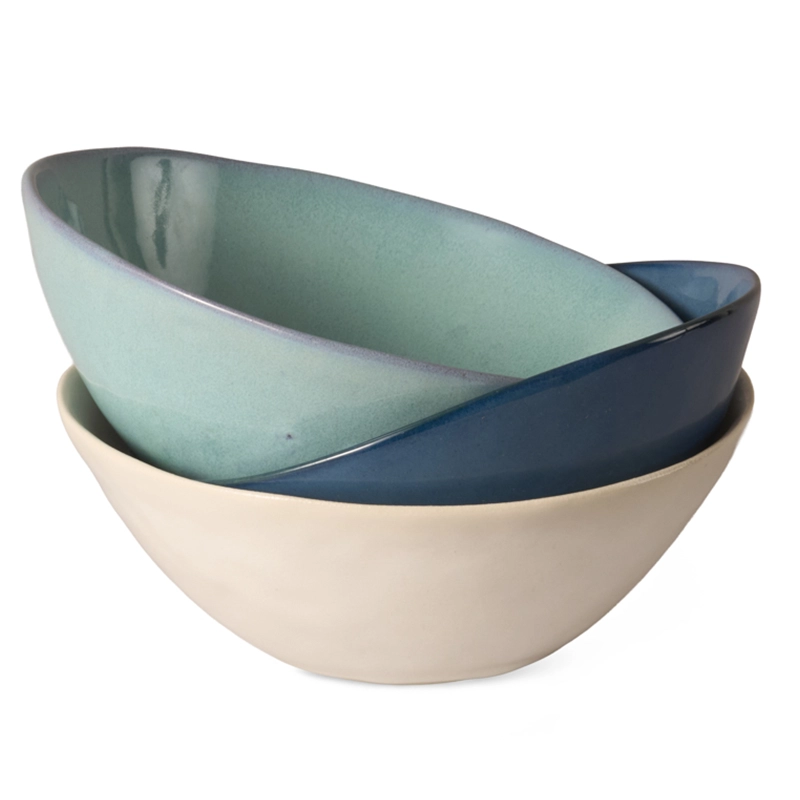 Perfect Hideaways set of three handcrafted ceramic bowls in shades of ocean blue, seafoam green, and soft white, elegantly stacked to showcase their organic shape and smooth glaze. Perfect Hideaways shop.