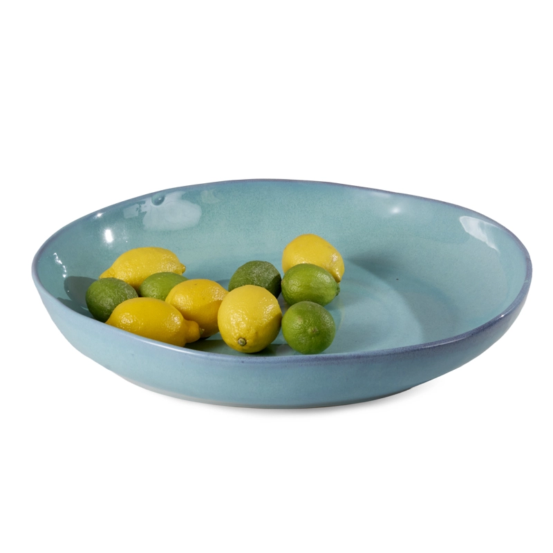Perfect Hideaways – A wide turquoise ceramic bowl filled with fresh lemons and limes, showcasing a smooth glossy glaze and subtle rim detailing. Perfect Hideaways shop.
