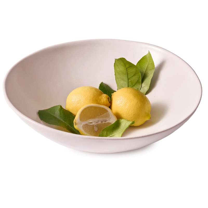 Perfect Hideaways — A large white ceramic serving bowl with a smooth matte finish, holding three fresh lemons and green leaves, styled on a plain white background. Perfect Hideaways shop.