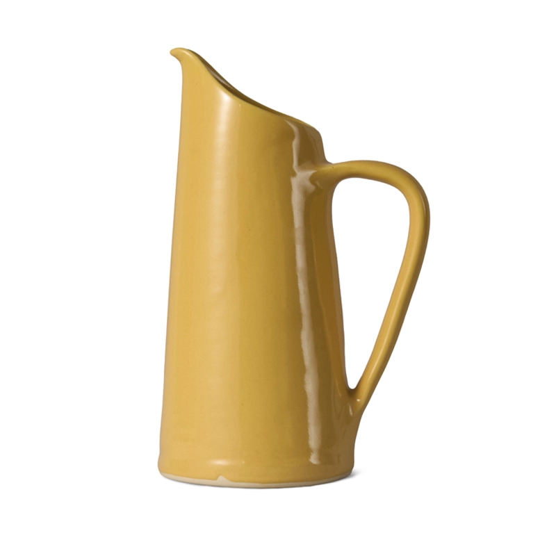 Perfect Hideaways mustard yellow ceramic jug with a tall, sleek shape and curved handle, designed for serving or displaying flowers. Perfect hideaways shop.