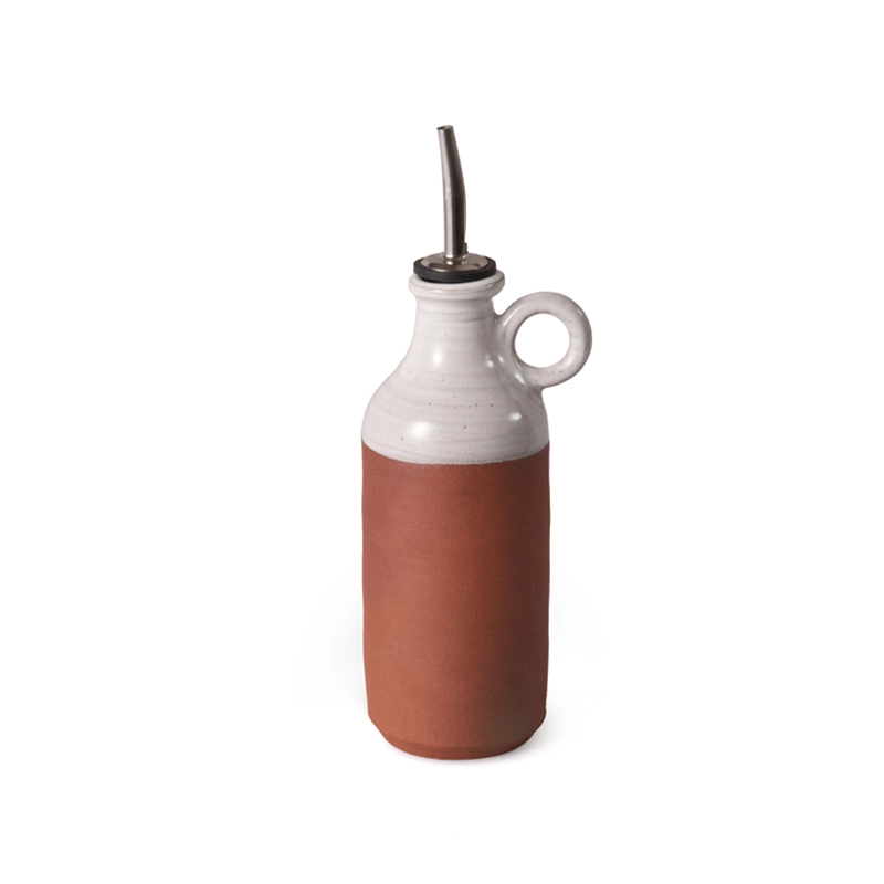 Perfect Hideaways ceramic oil pourer featuring a terracotta base and smooth white glazed upper half with a loop handle and metal spout, displayed against a plain white background. Perfect hideaways shop.