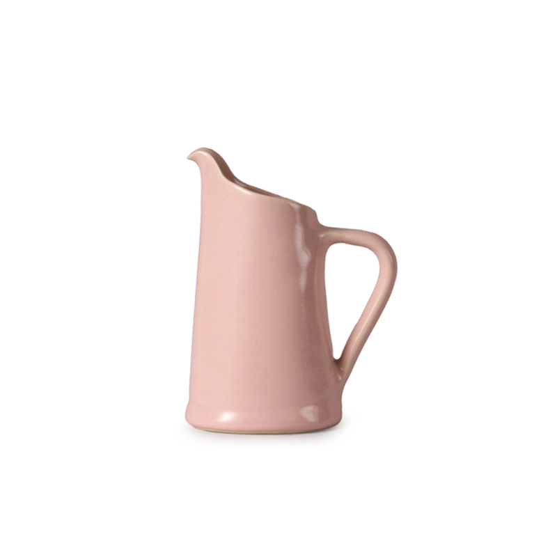 Perfect Hideaways soft pink ceramic jug with a curved handle and minimalist design, displayed on a white background. Perfect hideaways shop.